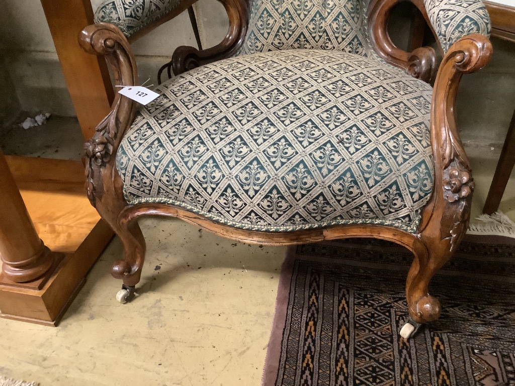 A Victorian carved walnut open armchair, width 66cm depth 75cm height 96cm